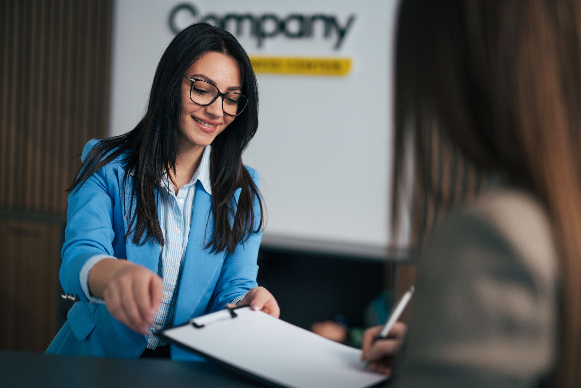 Unrecognizable person signing a contract in the office